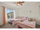 Bright bedroom with two twin beds, window, and colorful bedding at 385 N Flat Rock St, Aurora, CO 80018