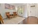 Living room with hardwood floors, two armchairs, and a large window at 385 N Flat Rock St, Aurora, CO 80018