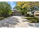 Two-story house with gray siding, brick accents, and a landscaped yard at 385 N Flat Rock St, Aurora, CO 80018