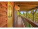 Wooden deck overlooking a scenic wooded view at 10333 Georgia Cir, Morrison, CO 80465