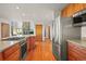 Open kitchen with stainless steel appliances and island at 10333 Georgia Cir, Morrison, CO 80465