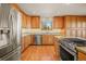 Kitchen with stainless steel appliances and wood cabinets at 10333 Georgia Cir, Morrison, CO 80465