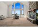 Spacious living room with stone fireplace and large windows at 10333 Georgia Cir, Morrison, CO 80465