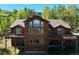 Two-story home with wood siding, multiple decks, and mountain views at 10333 Georgia Cir, Morrison, CO 80465