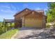 Attached garage with additional parking and mountain views at 10333 Georgia Cir, Morrison, CO 80465