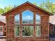 Large windows showcasing mountain views in a wood-sided home at 10333 Georgia Cir, Morrison, CO 80465