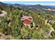 Mountain view home with a large deck and surrounding trees at 10333 Georgia Cir, Morrison, CO 80465