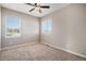 Well-lit bedroom with carpeted flooring, a ceiling fan, and multiple windows at 26550 E Euclid Pl, Aurora, CO 80016