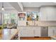 Modern kitchen with white cabinets, granite countertops, and stainless steel appliances at 141 N Gilpin St, Denver, CO 80218