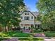 Two-story house with a charming front porch and landscaping at 141 N Gilpin St, Denver, CO 80218