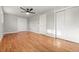 Hardwood floor bedroom with ceiling fan and neutral walls at 129 W 81St Pl, Denver, CO 80221