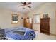 Bright bedroom with wood flooring, ceiling fan, and ample closet space at 31037 Witteman Rd, Conifer, CO 80433