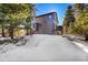 Two-story home with deck, snowy yard, and trees at 8959 Hillview Rd, Morrison, CO 80465