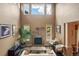 Spacious living room with high ceilings, fireplace and large windows at 4517 Tallyrand Cir, Castle Rock, CO 80104