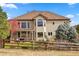 Spacious backyard with a covered patio and wood fence, offering outdoor entertaining space at 4517 Tallyrand Cir, Castle Rock, CO 80104