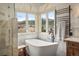 Bathroom with a soaking tub, shower, and heated towel rack at 4517 Tallyrand Cir, Castle Rock, CO 80104