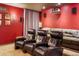 Home theater room with projector, large screen, and comfortable seating at 4517 Tallyrand Cir, Castle Rock, CO 80104