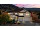 Two-story house with a three-car garage, mountain views and well-maintained landscaping at 4517 Tallyrand Cir, Castle Rock, CO 80104