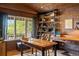 Rustic home office with exposed brick walls and built-in shelving at 4517 Tallyrand Cir, Castle Rock, CO 80104