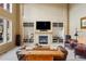 Living room with built-in shelving and a fireplace at 4517 Tallyrand Cir, Castle Rock, CO 80104