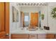 Double sink bathroom with a large mirror and wood cabinets at 4517 Tallyrand Cir, Castle Rock, CO 80104