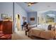 Bright main bedroom with a large bed, sitting area, and views at 4517 Tallyrand Cir, Castle Rock, CO 80104
