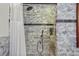 Walk-in shower with marble tile and safety features at 4517 Tallyrand Cir, Castle Rock, CO 80104