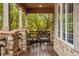 Covered porch with stone pillars and wicker chairs at 4517 Tallyrand Cir, Castle Rock, CO 80104