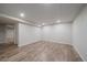 Unfinished basement area with laminate flooring at 1827 Quail St # 3, Lakewood, CO 80215