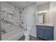 Modern bathroom with navy blue vanity and marble tile at 1827 Quail St # 3, Lakewood, CO 80215