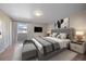 Spacious primary bedroom with wood floors and access to a private balcony at 1827 Quail St # 3, Lakewood, CO 80215