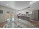 Modern kitchen with island, stainless steel appliances, and glass dining table at 1827 Quail St # 3, Lakewood, CO 80215