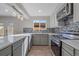 Renovated kitchen boasts modern appliances and stylish gray cabinets at 1827 Quail St # 3, Lakewood, CO 80215