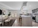 Modern kitchen with island, stainless steel appliances, and glass dining table at 1827 Quail St # 3, Lakewood, CO 80215