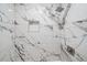 Modern shower with marble tile and built-in shelf at 1827 Quail St # 3, Lakewood, CO 80215
