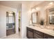 Main bathroom with double vanity and walk-in closet at 15535 W Auburn Ave, Lakewood, CO 80228