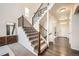 Bright entryway with hardwood floors and staircase at 15535 W Auburn Ave, Lakewood, CO 80228