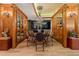 Elegant formal dining room with a large glass-top table and wood cabinetry at 2001 Lincoln St # 3223, Denver, CO 80202