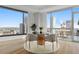 Bright dining area with access to balcony and city views at 2001 Lincoln St # 3223, Denver, CO 80202