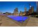 Rooftop pool at night with city skyline in background at 2001 Lincoln St # 3223, Denver, CO 80202