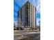 Ten-story residential building with brick and white accents at 550 E 12Th Ave # 907, Denver, CO 80203