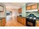View of kitchen and living room with hardwood floors at 550 E 12Th Ave # 907, Denver, CO 80203