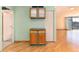 Small kitchen with wood cabinets and green accents at 550 E 12Th Ave # 907, Denver, CO 80203