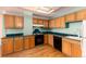 Kitchen with wood cabinets, laminate countertops, and appliances at 550 E 12Th Ave # 907, Denver, CO 80203