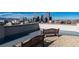Relaxing rooftop deck with two benches and city views at 550 E 12Th Ave # 907, Denver, CO 80203