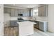 Modern kitchen with gray cabinets, white countertops, and stainless steel appliances at 13332 E 110Th Way, Commerce City, CO 80022