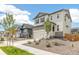 Beige two-story house with stone facade and landscaping at 13332 E 110Th Way, Commerce City, CO 80022