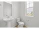 Simple bathroom with pedestal sink and window at 13332 E 110Th Way, Commerce City, CO 80022