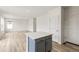 Modern kitchen island with white countertop and gray cabinets at 13332 E 110Th Way, Commerce City, CO 80022