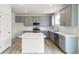 Modern kitchen with gray cabinets, white countertops, and stainless steel appliances at 13332 E 110Th Way, Commerce City, CO 80022